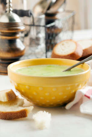Cream soup with potato and green peasの写真素材