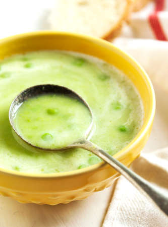 Cream soup with potato and green peasの写真素材