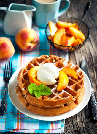 Belgian waffles with caramelized apple, ice cream and honeyの写真素材