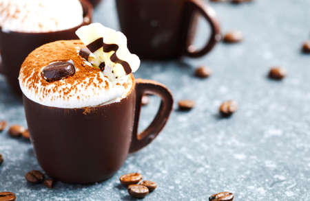 Coffee mousse with whipped cream in chocolate cupの写真素材