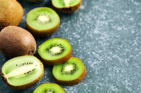 Kiwi fruits on stone background with copy spaceの写真素材