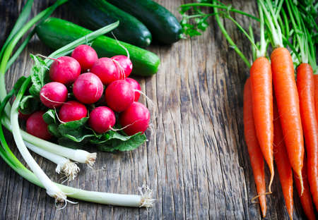 Spring vegetables on wooden background.の写真素材