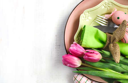 Easter table setting with fresh tulips and festive decoration, top viewの写真素材
