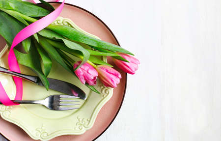 Festive table setting with fresh tulips, top viewの写真素材