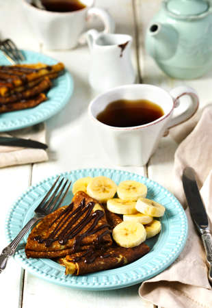 Crepes with banana and chocolate sauce.の写真素材