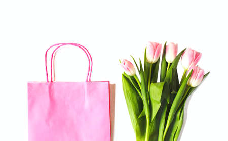 Pink paper shopping bag with beautiful pink tulips bouquet, Spring Sale, top viewの写真素材
