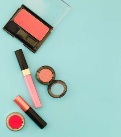 Beauty flat lay with woman make up products and accessories in pink color. Woman make up products and accessories in pink color on pastel light blue background, top viewの写真素材