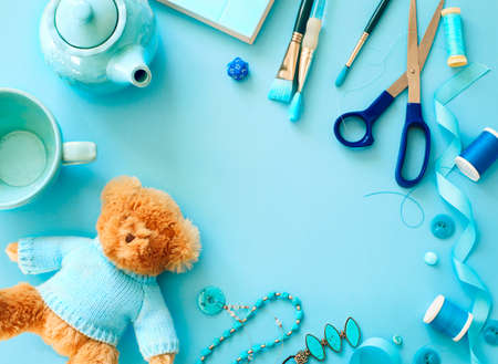 Flat lay blue color objects and accessories frame on light blue background with copy spaceの写真素材