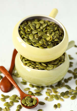 Raw pumpkin seeds in bowlの写真素材