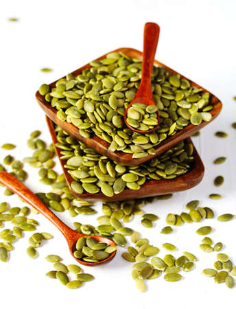 Raw pumpkin seeds in bowlの写真素材