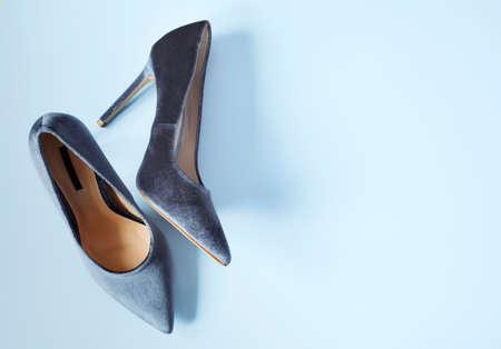 Velvet grey women high heel shoes. Velvet pumps. Trendy female background, top view, copy sapceの写真素材