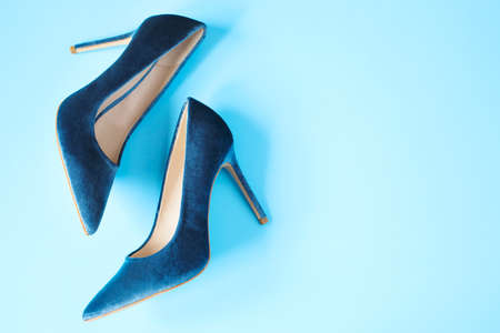 Velvet blue women high heel shoes. Velvet pumps. Trendy female background, top view, copy sapceの写真素材