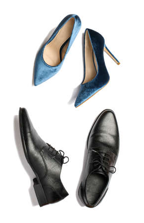 Elegant leather men's shoes and velvet blue women's high heel shoes, top view.の写真素材