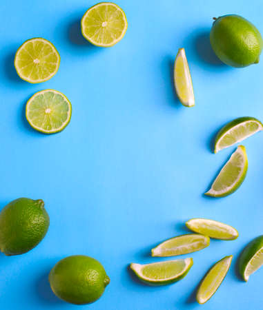 Fresh limes on light blue background, copy spaceの写真素材