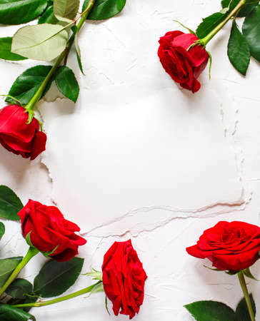 Vintage paper with space for text and red roses on white background.の写真素材