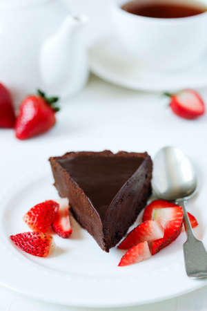 Piece of chocolate cake served with strawberries.の写真素材