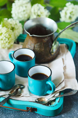 Cups of coffee and copper cerve on tray, top viewの写真素材