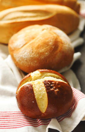 Assortment of baked bread on wooden table backgroundの写真素材