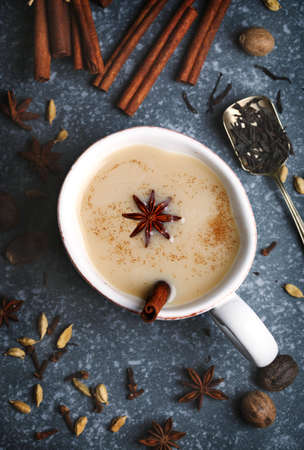 Traditional indian masala chai tea with spices in cup, top viewの写真素材