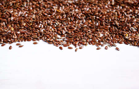 Brown flax on white wojden background with copy spaceの写真素材