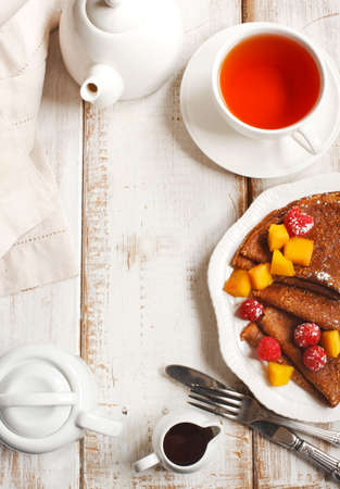 Crepes with fresh mango and raspberriesの写真素材