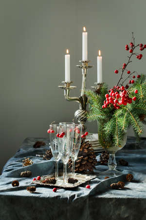 Christmas table setting. Champagne glasses and candles on the table. Prepering for Christmas dinnerの写真素材