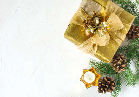Christmas flatlay background. Christmas gift box and fir branches on white background. Top view.の写真素材