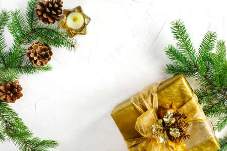 Christmas flatlay background. Christmas gift box and fir branches on white background. Top view.の写真素材