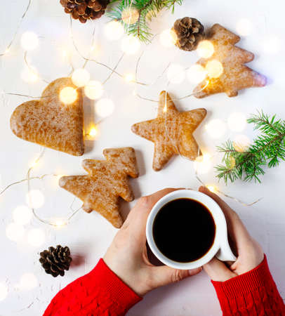 Woman's hand is holding cup of coffee, top viewの写真素材