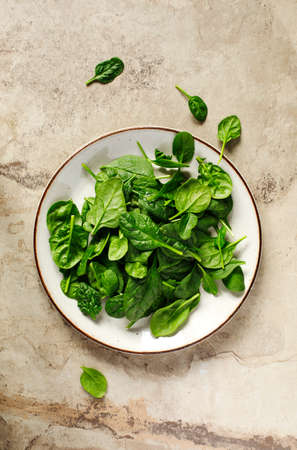 Fresh spinach on plate, top viewの写真素材