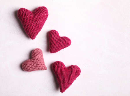 Crochet hearts on pink background. Valentine's Day concept, copy spaceの写真素材