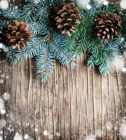 Fir Branches With Pine Cones And Snow Flakes. Christmas Holidays Background, copy spaceの写真素材