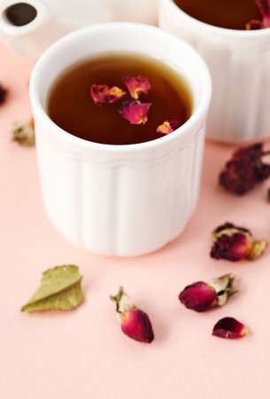 Herbal tea with roses on pink backgroundの写真素材