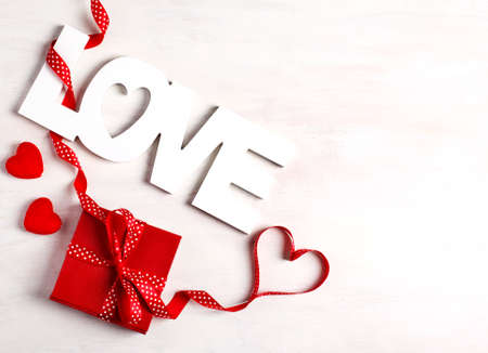Word Love and red gift box on white background, copy spaceの写真素材