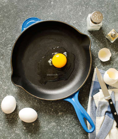 Raw chicken egg in a frying pan, top viewの写真素材