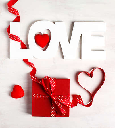 Word Love and red gift box on white backgroundの写真素材