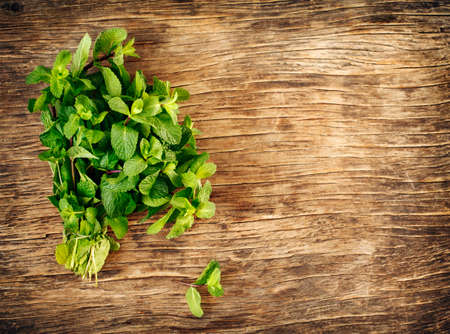 Fresh mint leaves on wooden background, copy spaceの写真素材