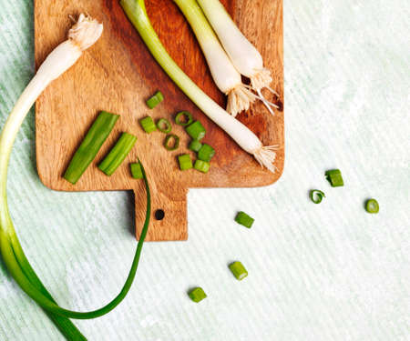 Green onion on wooden cooking board, copy spaceの写真素材