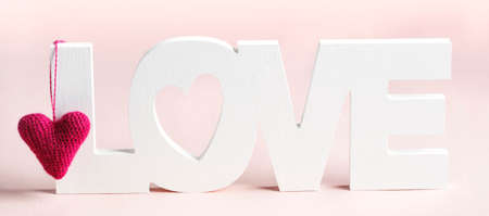 Word Love and pink hearts at pink backgroundの写真素材