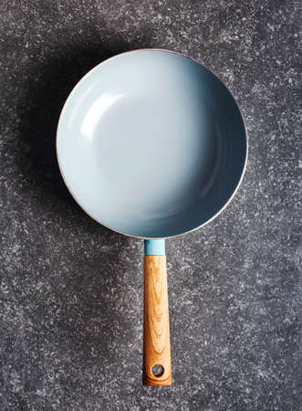 Empty cooking pan on grey stone background, top view, copy spaceの写真素材