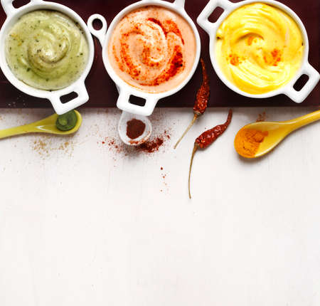Vegan almonds mayonnaise with wasabi, chilli and turmeric. Dairy, egg and soy-free. Top view, copy space.の写真素材