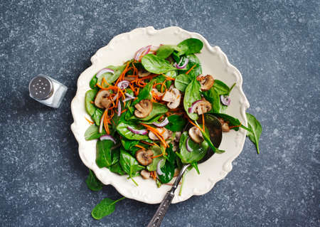 Spinach salad with sherried mushrooms and carrots, top viewの写真素材