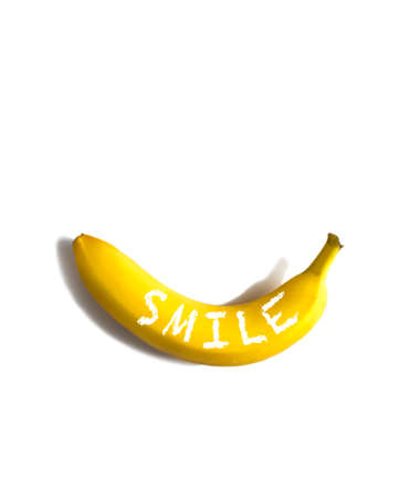 Ripe banana with word Smile on white background, flatlay, copy spaceの写真素材