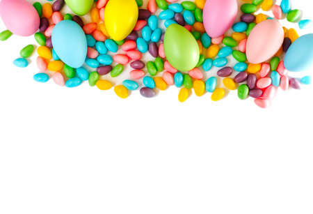 Easter decoration eggs and candy on white background, copy space. Easter backgroundの写真素材
