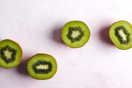 Kiwi fruit on pink background, top viewの写真素材