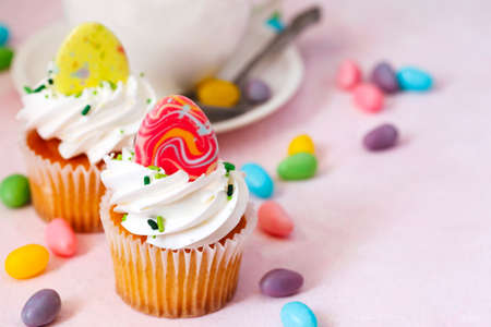 Easter vanilla cupcakes on pink background, copy spaceの写真素材