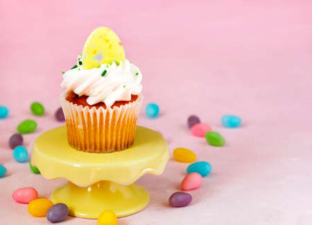 Easter vanilla cupcakes on pink background, copy spaceの写真素材