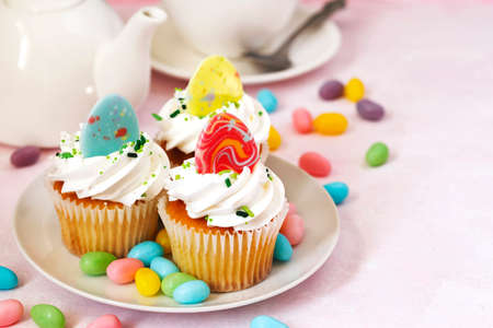 Easter vanilla cupcakes on pink background, copy spaceの写真素材