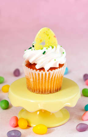 Cupcake on a cake stand on pink backgroundの写真素材