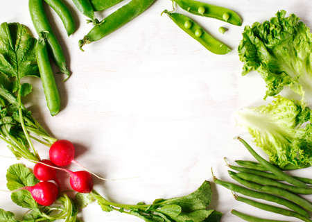 Spring vegetables on white wooden background with copy space.の写真素材